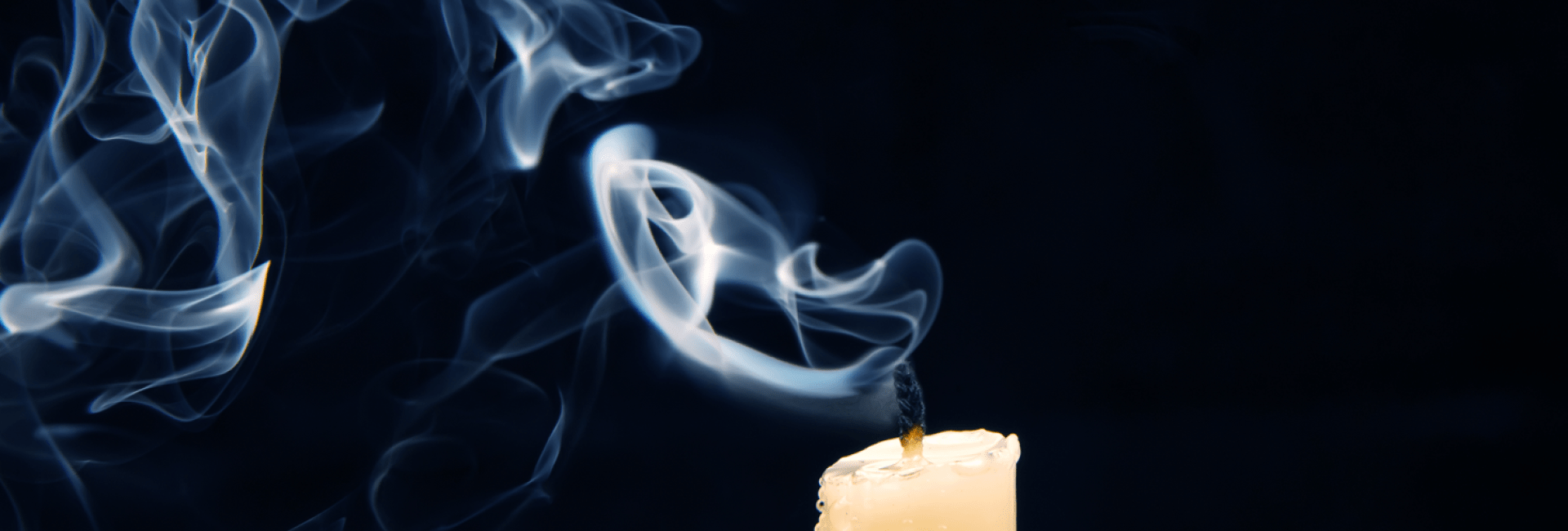 An extinguished candle with rising smoke, evoking the idea of foresight and the consequences of actions.