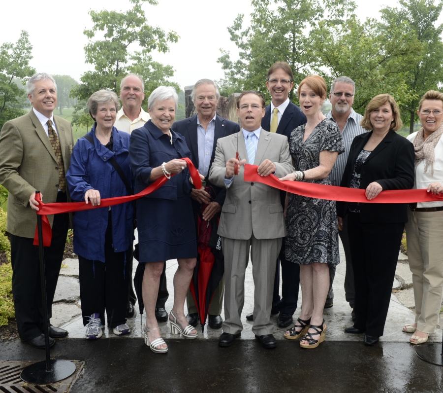 group of people cutting a ribbon