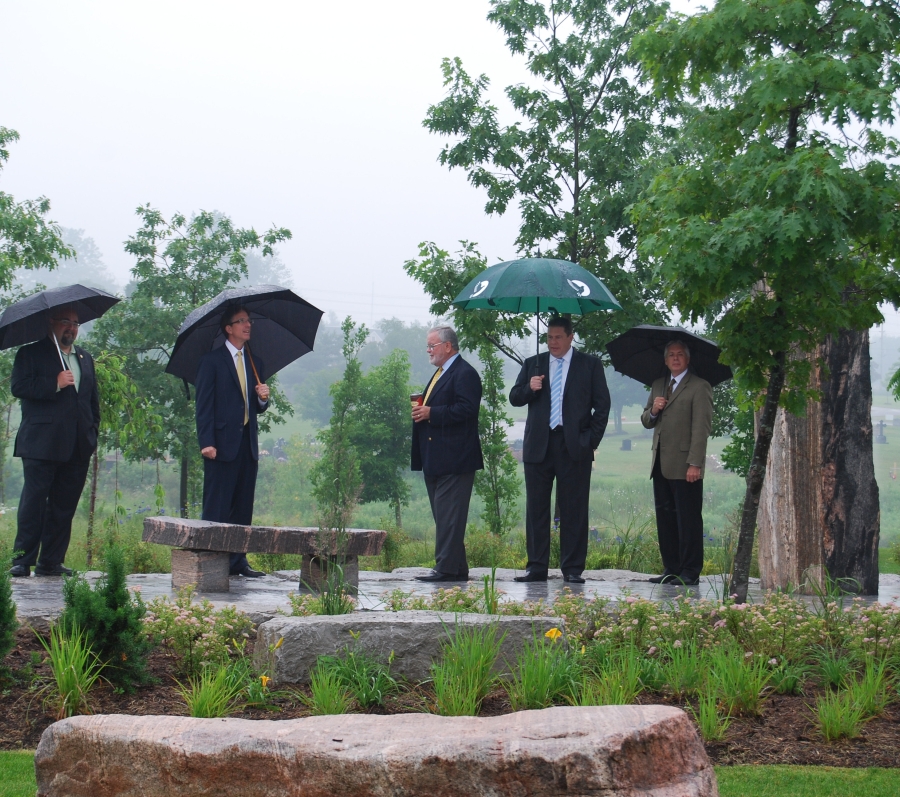 group of people standing with umbrellas