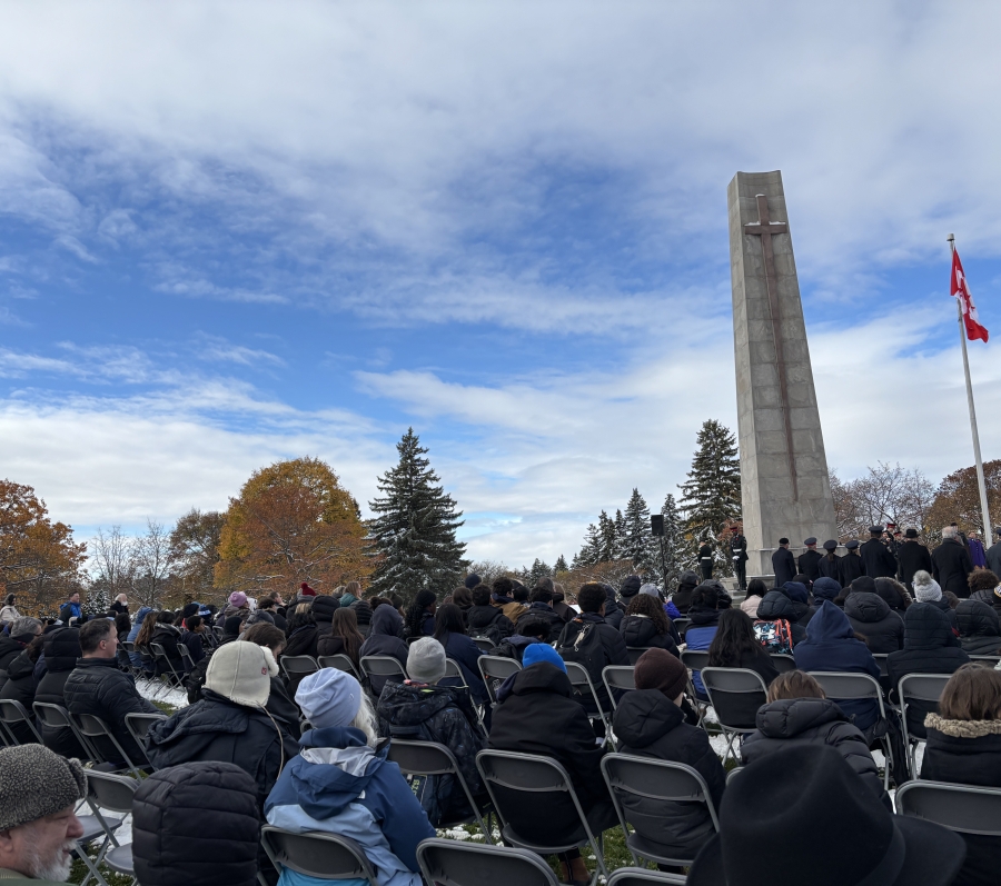 people sitting down for a Remembrance Day service