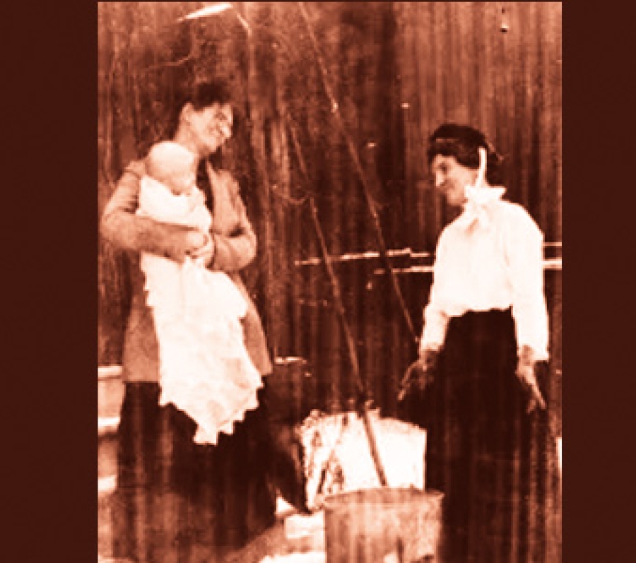 The staged picture entitled “Public health nurse Janet Neilson (right) on a home visit” shows the uniform she had to wear: it includes a black bonnet with white streamers. She carried supplies in a market basket.