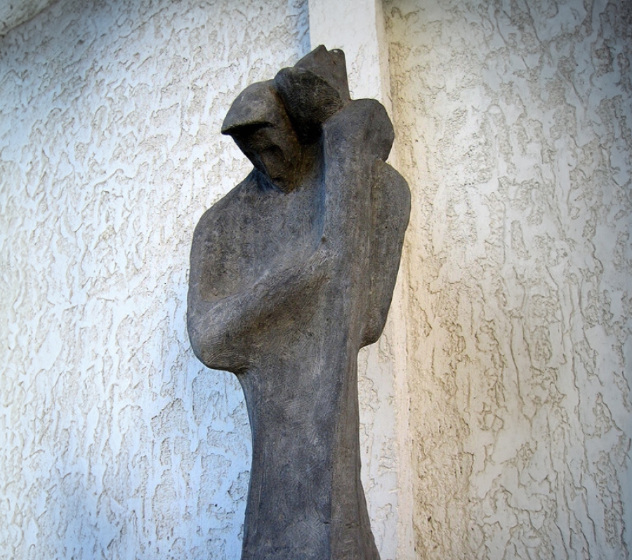 Figure of man holding a child