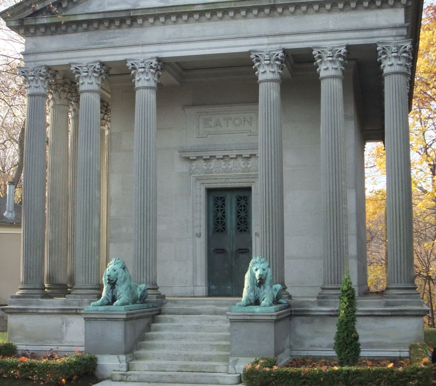 a grand building with bronzed lions in front