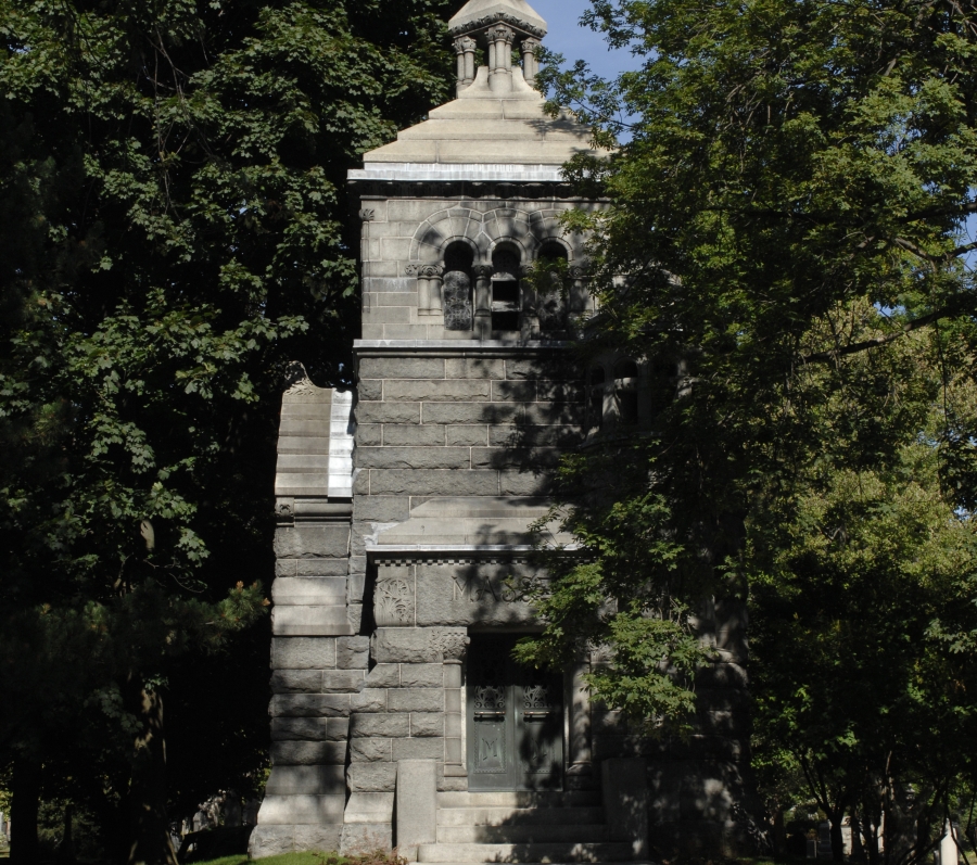 tall brick structure with steps surrounded by trees