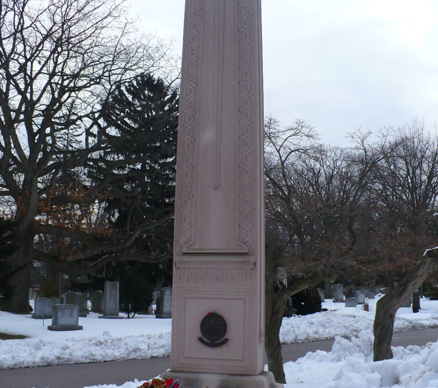 tall memorial monument with wreaths