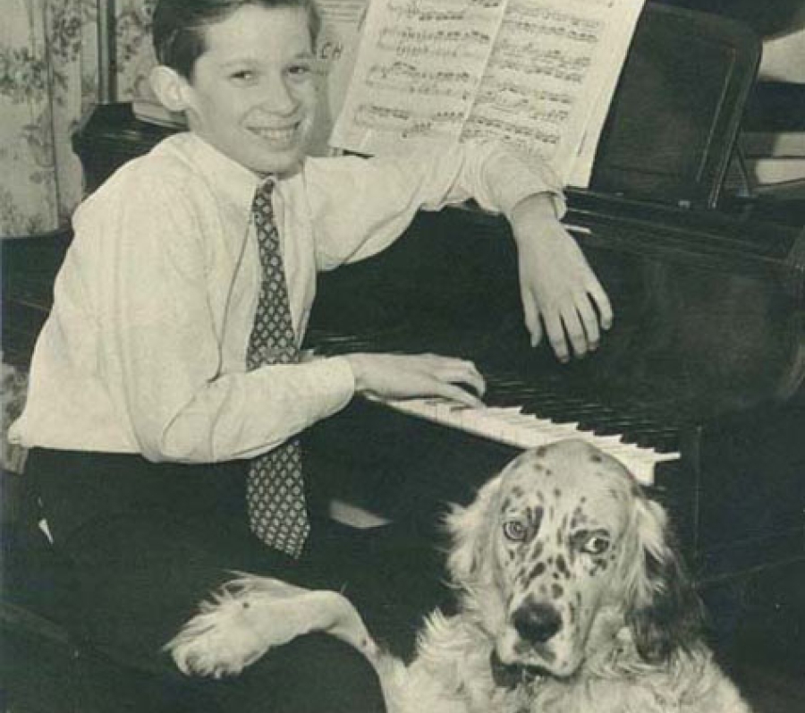 young boy with his dog at a piano