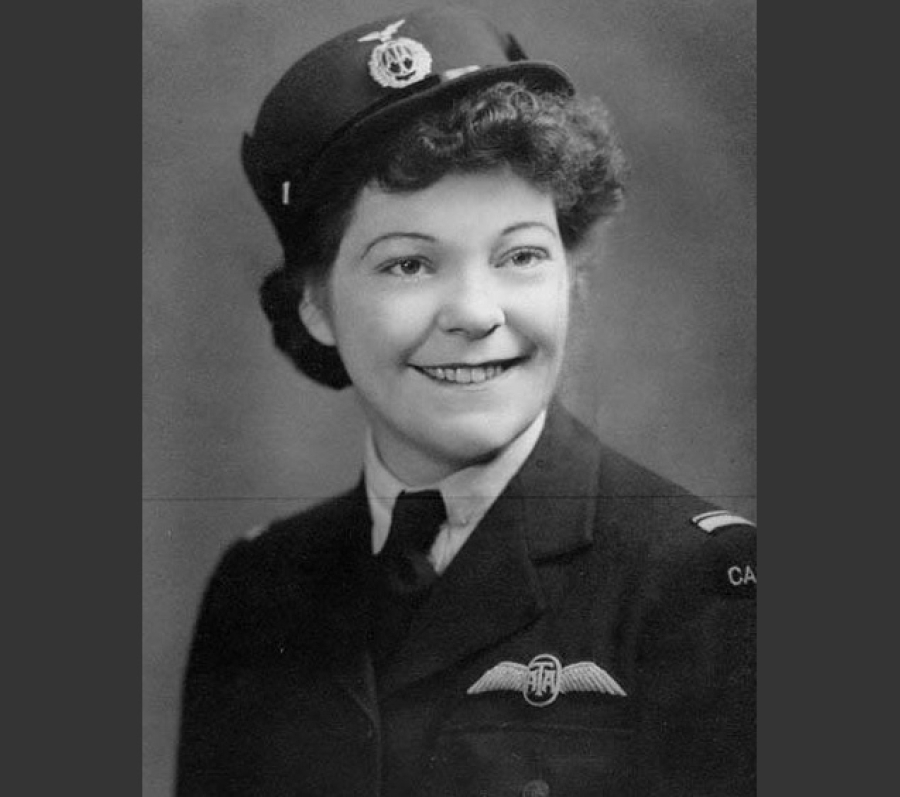 A vintage black‑and‑white portrait of Marion Alice Powell-Orr wearing a peaked cap with an insignia and a dark military jacket. The jacket features a winged badge on the chest and shoulder markings. The person is posed against a softly lit studio backdrop.