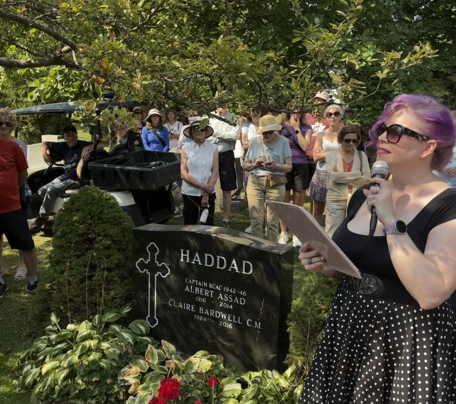 people gathered around a grave