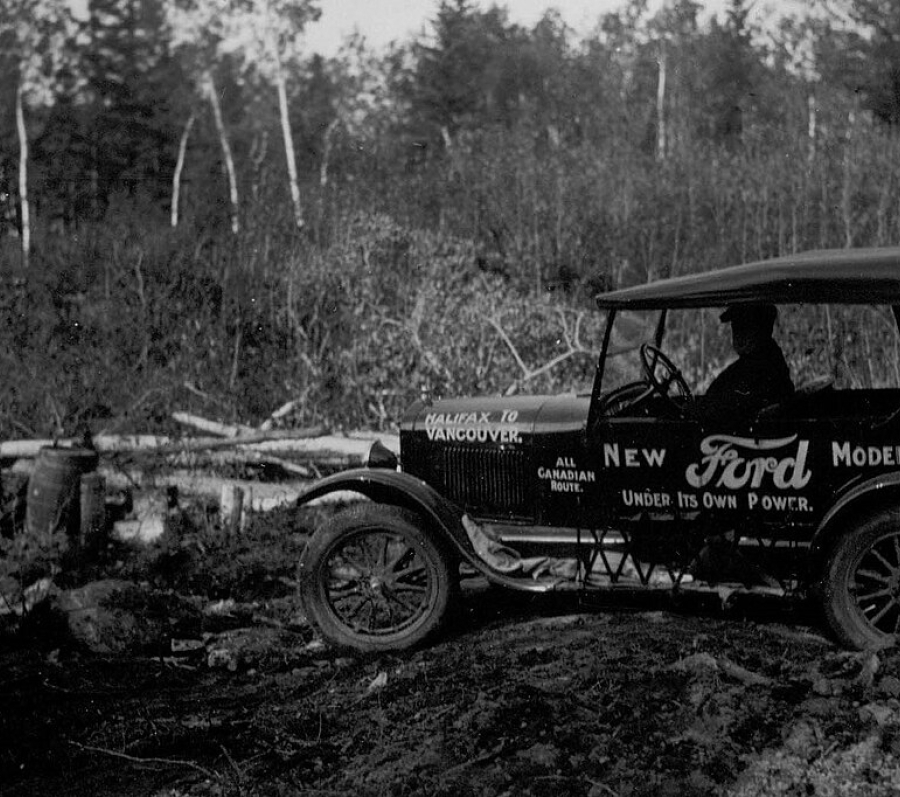 a very old Ford vehicle in black and white