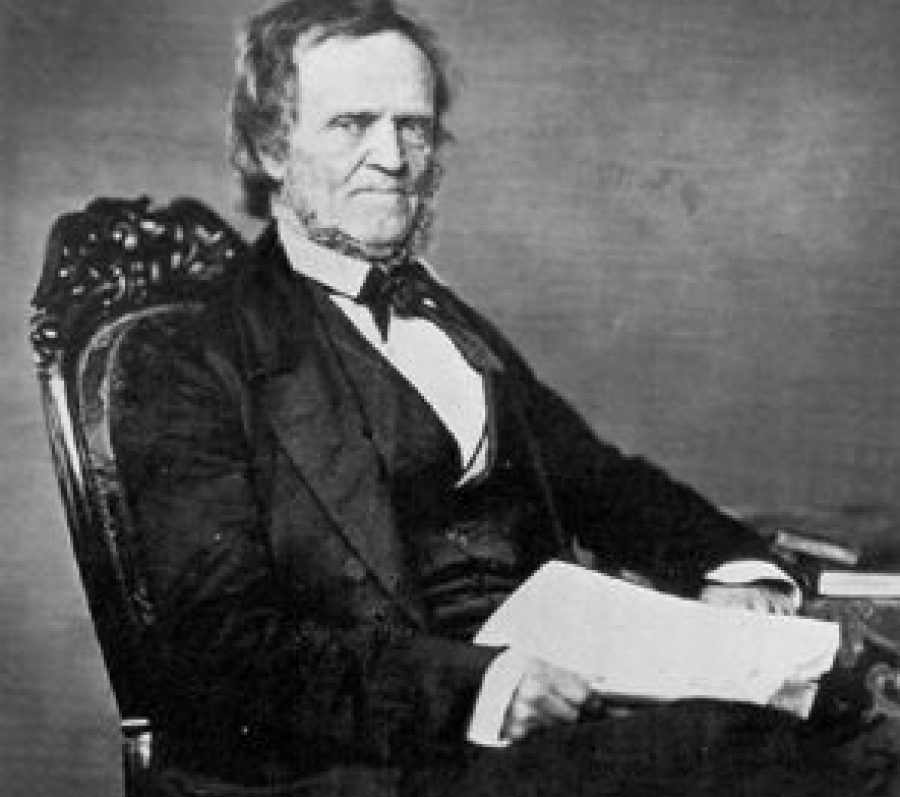 man in a suit sitting in a chair