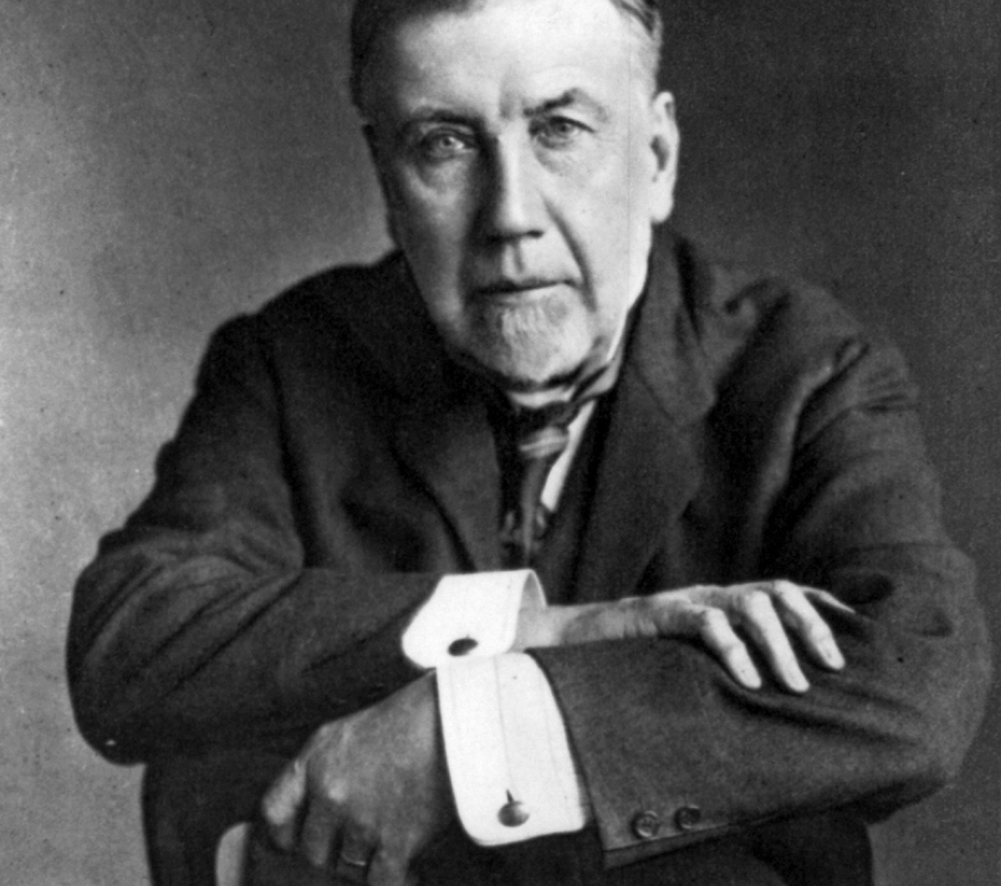 headshot of a man in a suit sitting in a chair