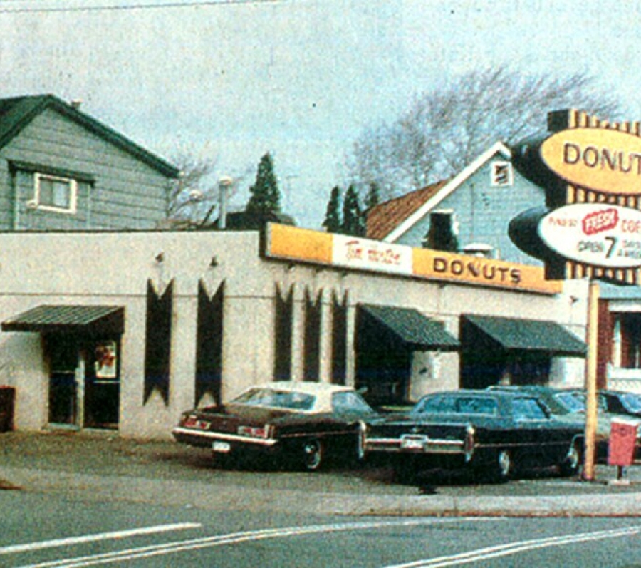 building with a donut sign out front