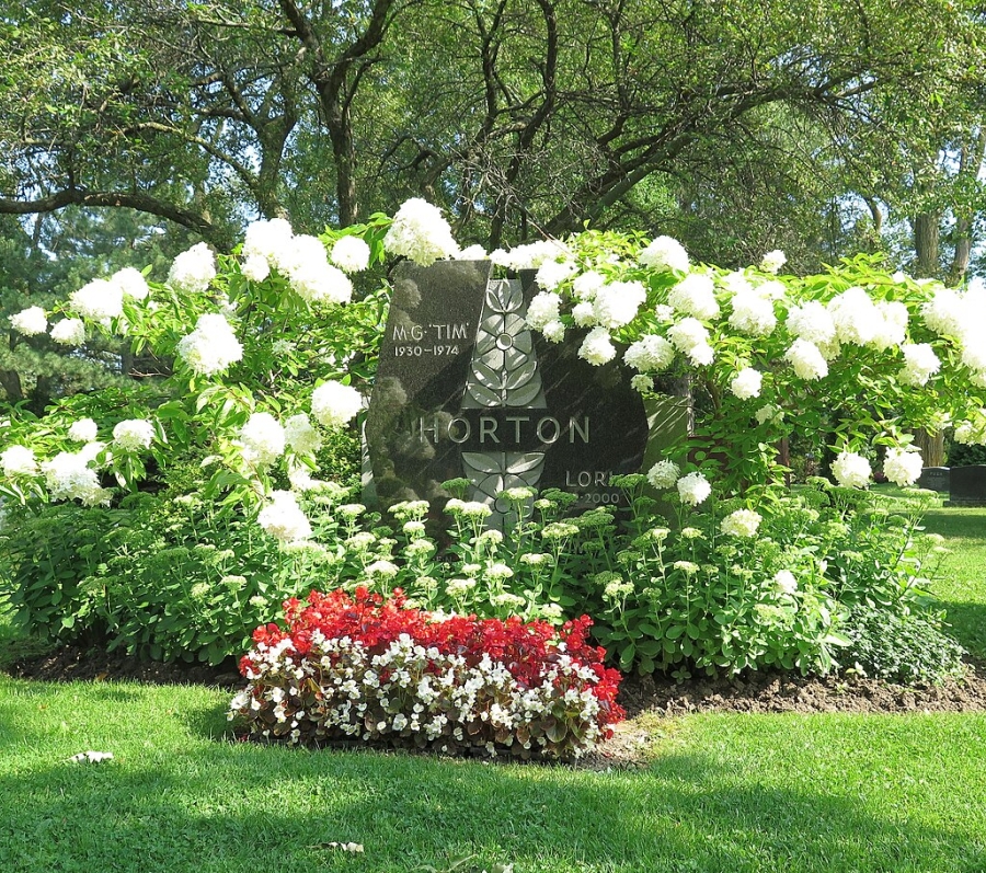 the grave of Tim Horton surrounded by flowers