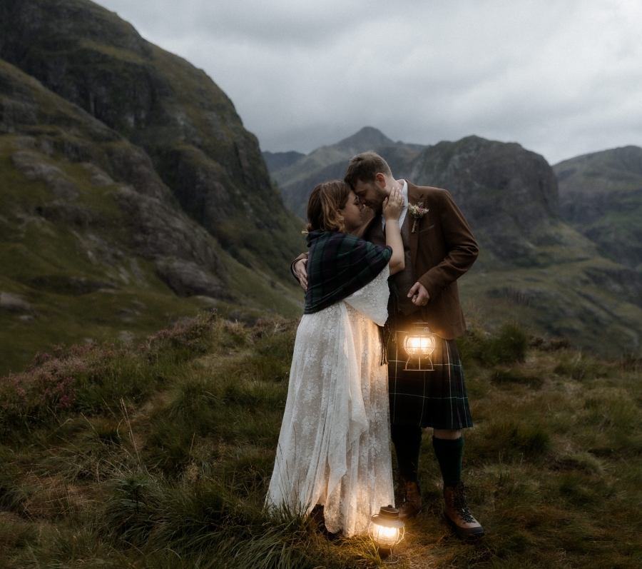 Kaitlyn and Dan standing together with a beautiful landscape in the background.