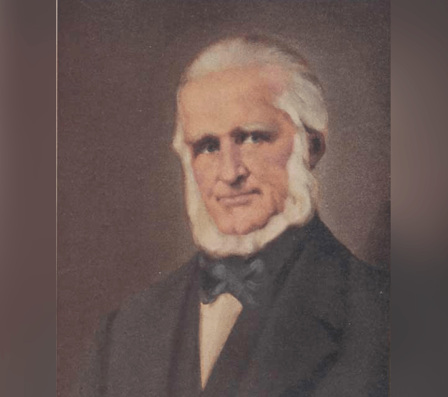 Painted portrait of Bartholomew Bull, known as the Patriarch of Spadunk, shown from the chest up wearing a dark suit and bow tie against a muted background.