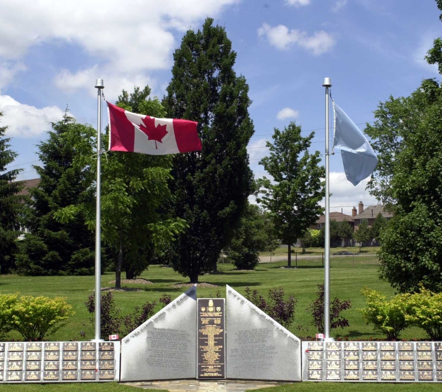 Korean War Memorial with Canadian flag and trees
