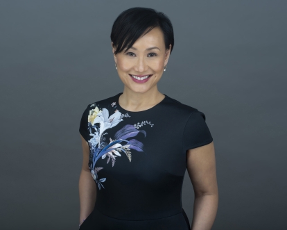 asian woman smiling with a black tshirt with flowers on it