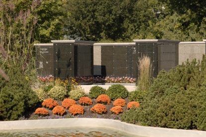 granite columbaria with orange flowers at Mount Pleasant cemetery