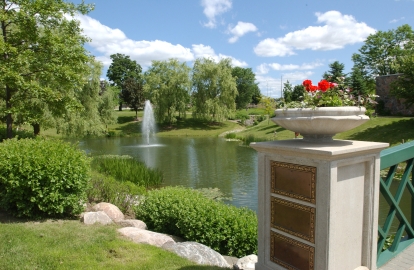 bridge, pond, fountain and trees in the garden of remembrance