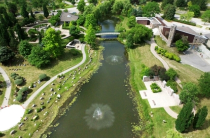 Aerial photograph showing ponds, memorial areas, and tree‑lined paths.