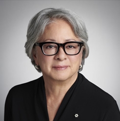 Asian woman with grey hair and glasses and a black shirt