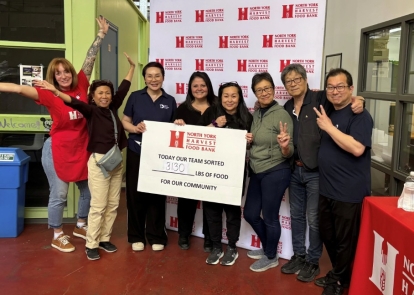 staff holding a big cheque for a food bank