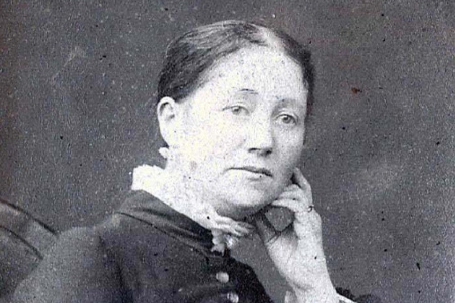 Historic portrait of a seated woman in Victorian-era clothing.