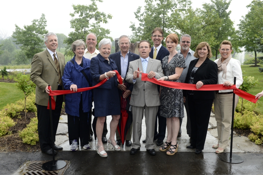 group of people cutting a ribbon