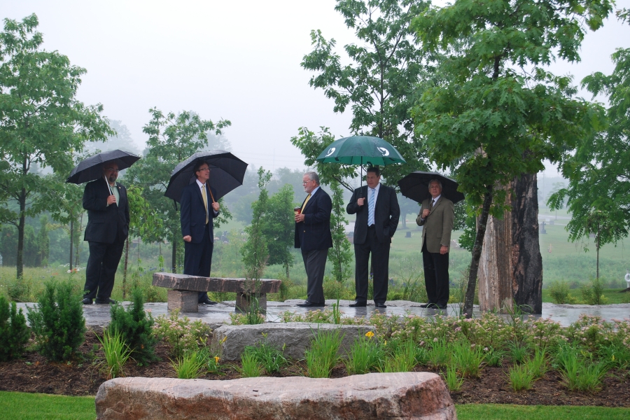 group of people standing with umbrellas