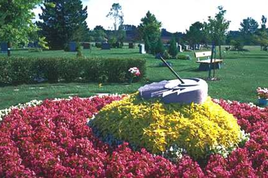 sundial at elgin mills with lots of flowers