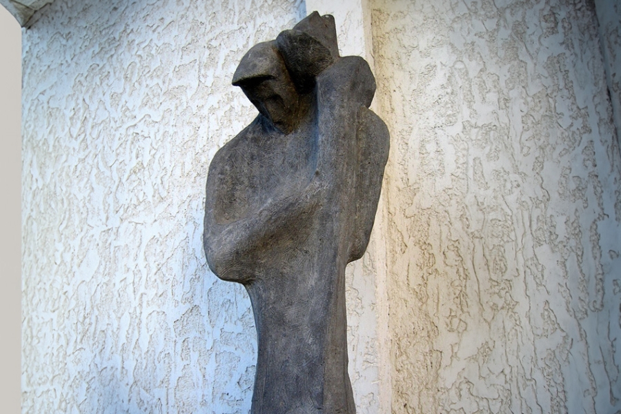 Figure of man holding a child