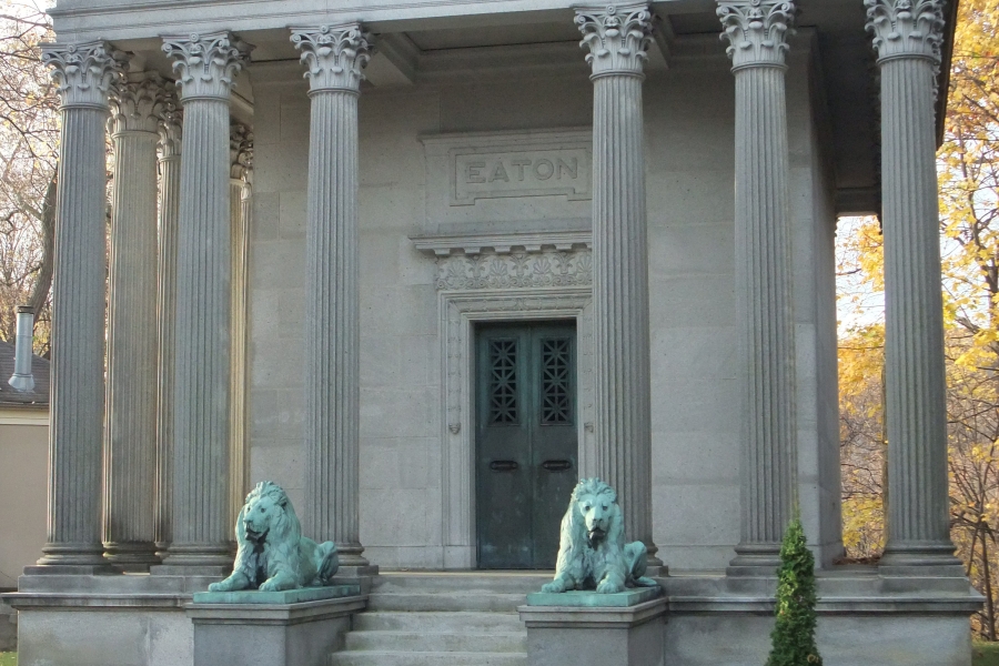 a grand building with bronzed lions in front