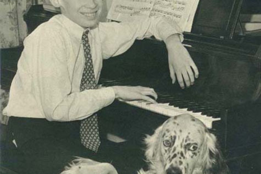 young boy with his dog at a piano