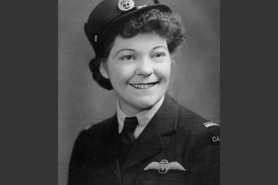 A vintage black‑and‑white portrait of Marion Alice Powell-Orr wearing a peaked cap with an insignia and a dark military jacket. The jacket features a winged badge on the chest and shoulder markings. The person is posed against a softly lit studio backdrop.