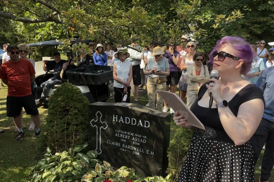 people gathered around a grave