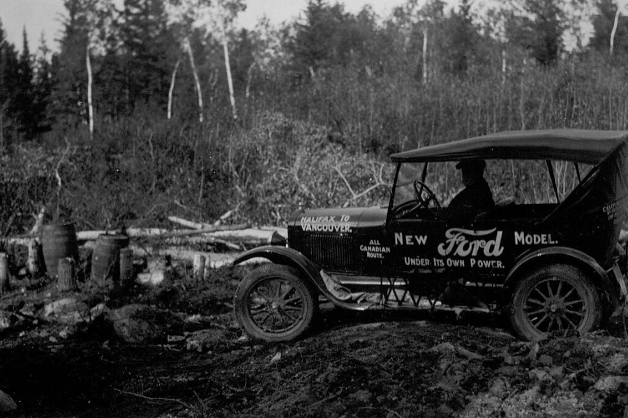a very old Ford vehicle in black and white