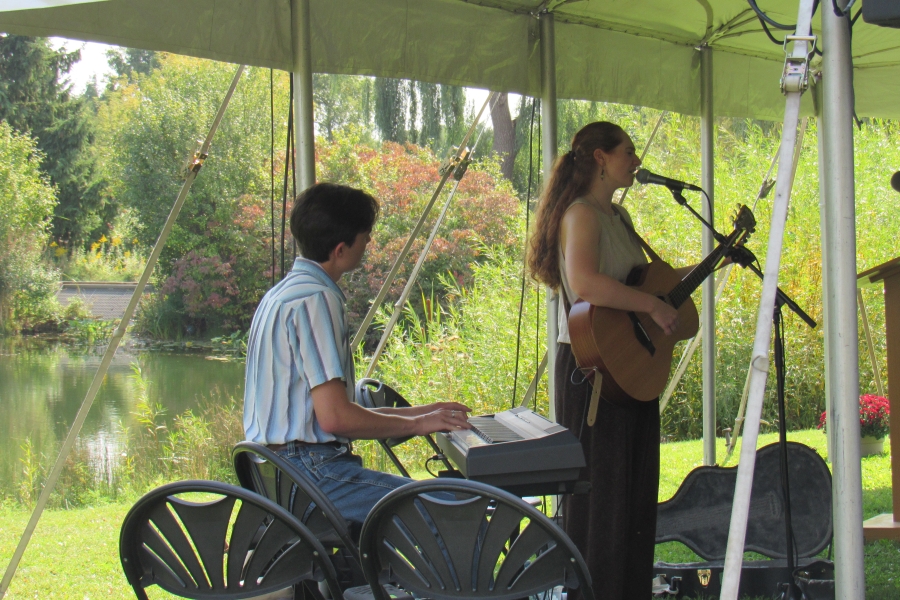 woman playing a guitar and a man playing a keyboard