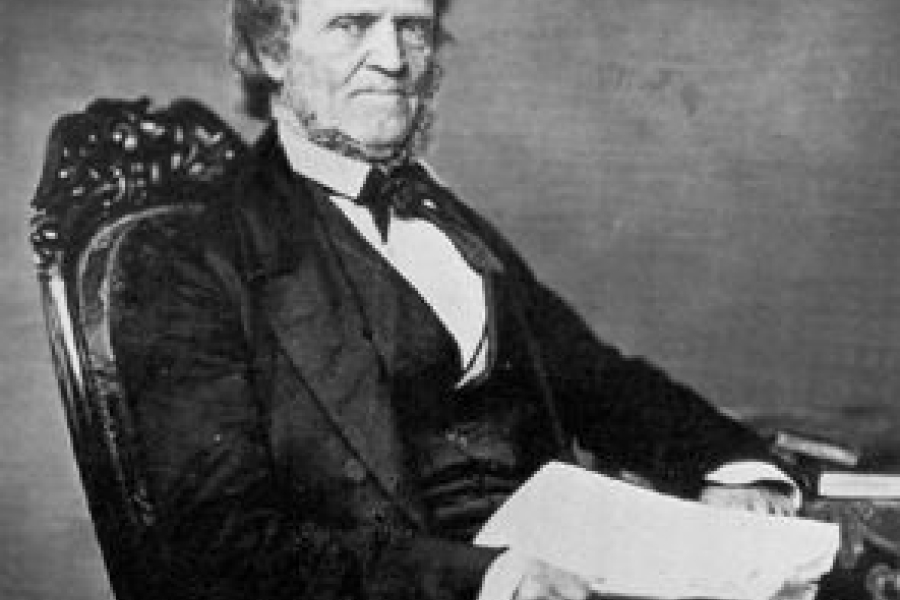 man in a suit sitting in a chair