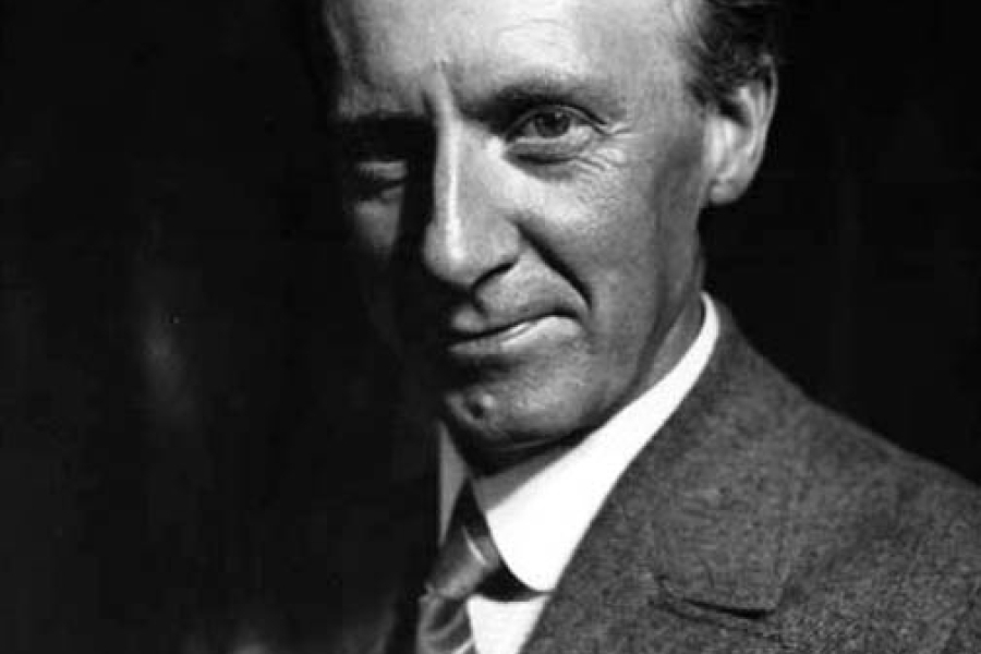 black and white headshot of a man in a suit