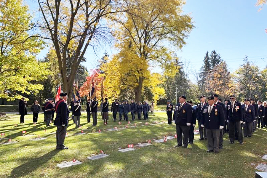 Attendees gathered for a remembrance service on cemetery grounds.
