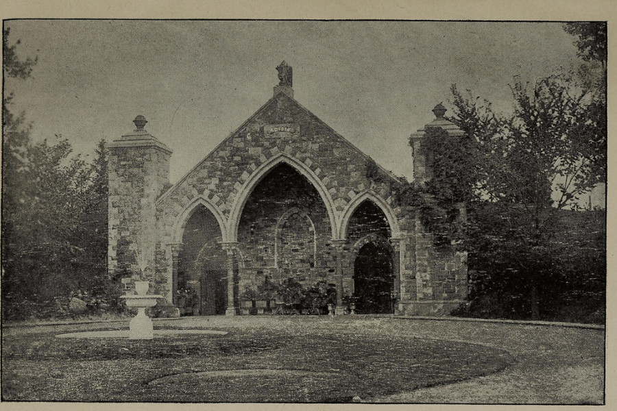Alt text: Black-and-white historic photograph of a stone Gothic-style building labeled “Public Vault—Mount Pleasant,” featuring three pointed arch entrances and set within a landscaped cemetery.