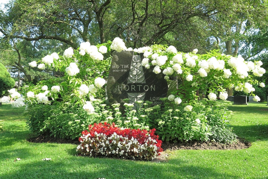 the grave of Tim Horton surrounded by flowers