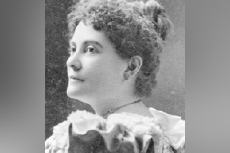 Black‑and‑white archival portrait of Augusta Stowe Gullen shown in profile, wearing a high‑collared Victorian‑era dress with decorative detailing at the neckline, her hair styled up, against a plain studio background.