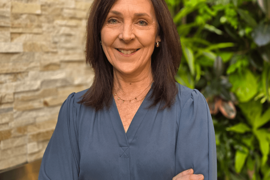 dark haired woman with her arms crossed