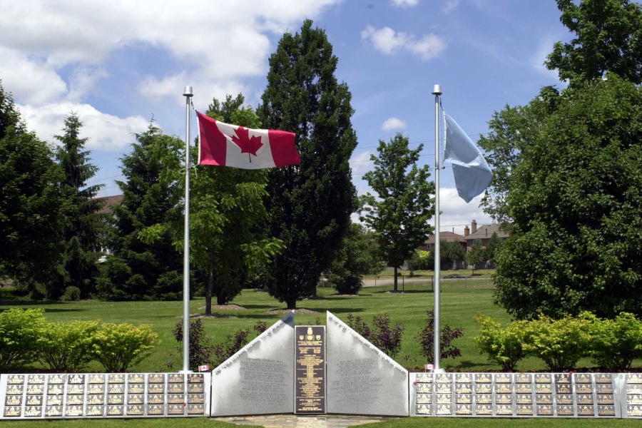 Korean War Memorial with Canadian flag and trees