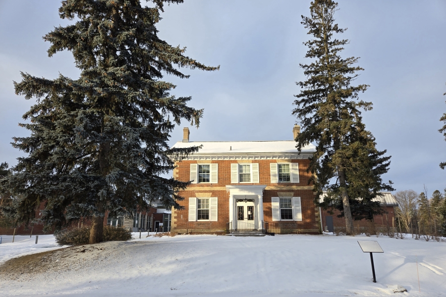 a house in the snow surrounded by trees