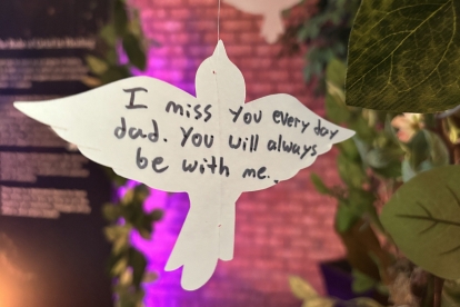 White dove note reading “I miss you every day dad.”