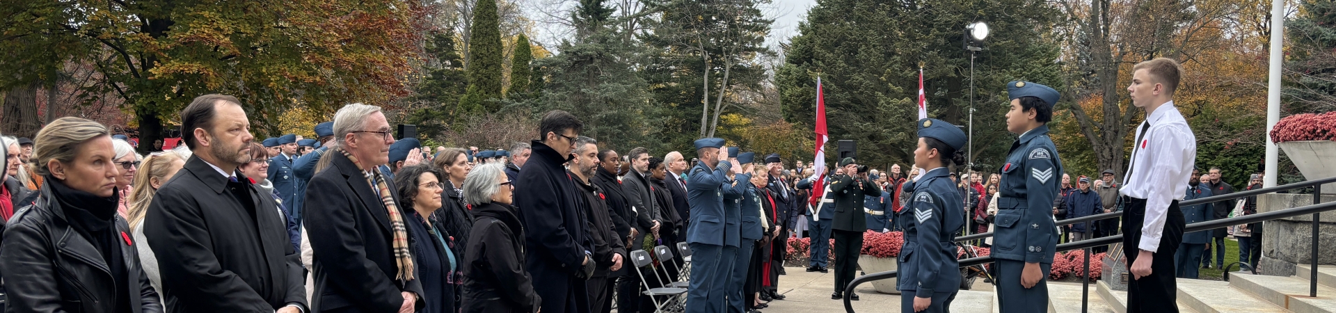people and soldiers standing on guard for Remembrance Day
